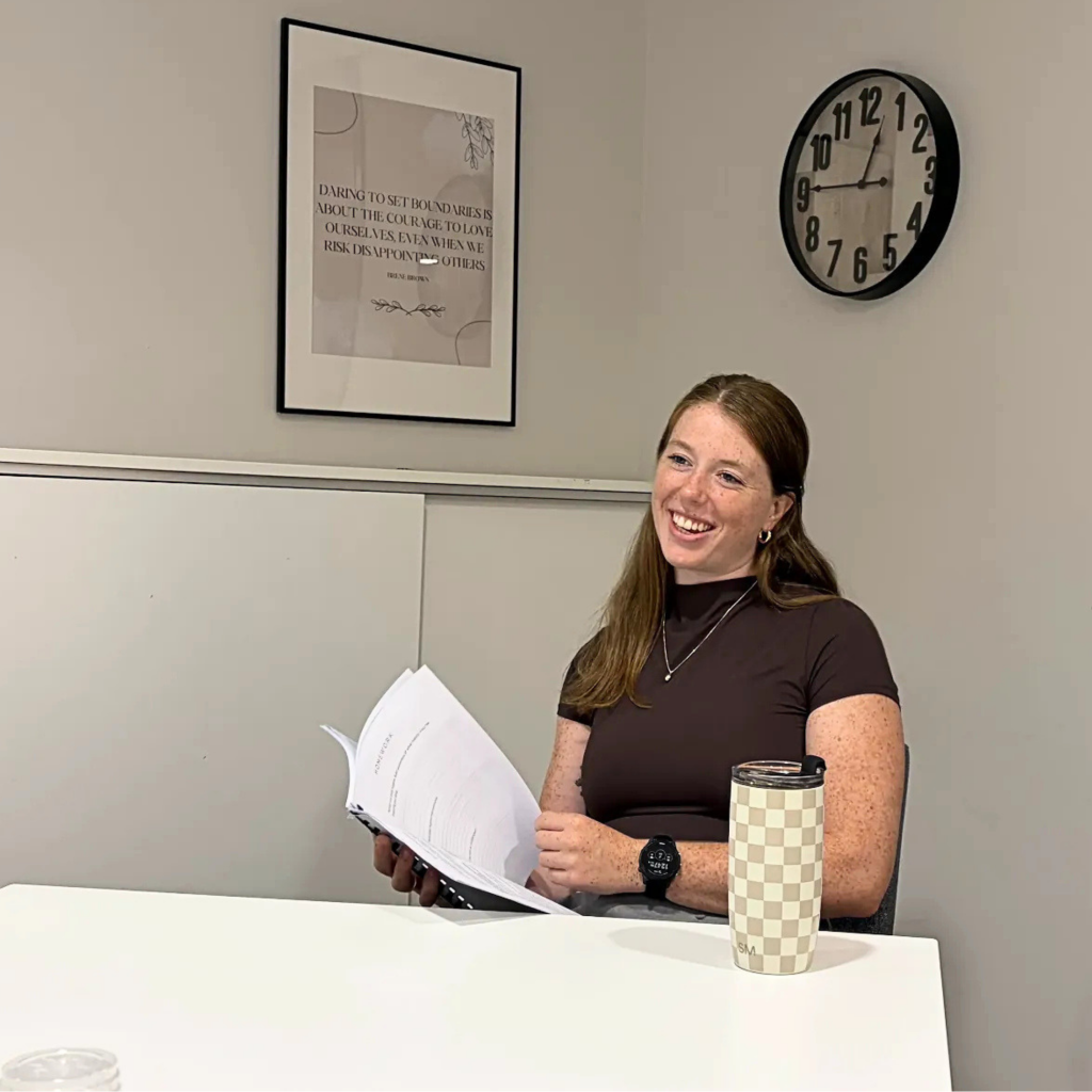 Bronwyn O'Connor, Registered Psychotherapist (Qualifying) at MindSpa Mental Health Centre, reviewing session materials in her Gloucester, Ottawa office