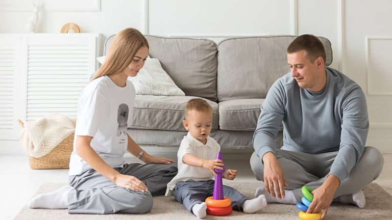Parents spending time with their young child at home