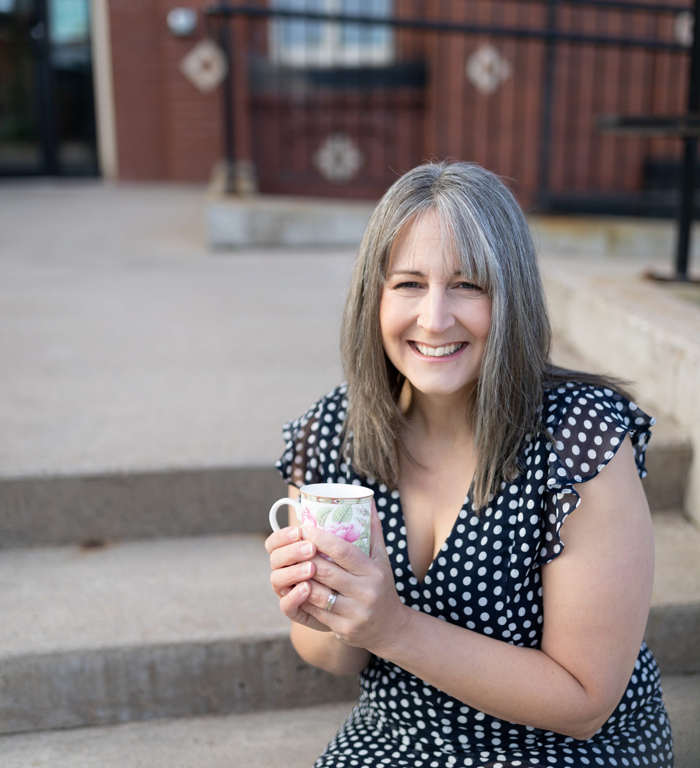 Rose Clark, Registered Psychotherapist (Qualifying) at MindSpa Kanata, smiling with a cup of tea